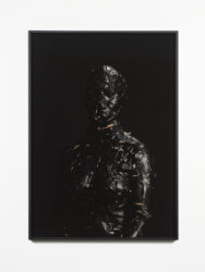 Photograph of figure wrapped in black tape
