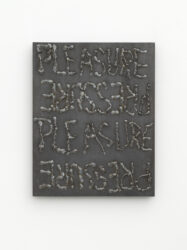 Reproduction of a steel plate with the words "pressure" and "pleasure" written in welded metal on the surface
