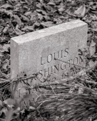 Black-and-white photograph of a headstone, reading "Louis Washington"